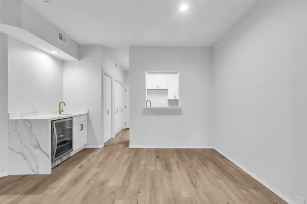 a view of a kitchen with wooden floor and a sink