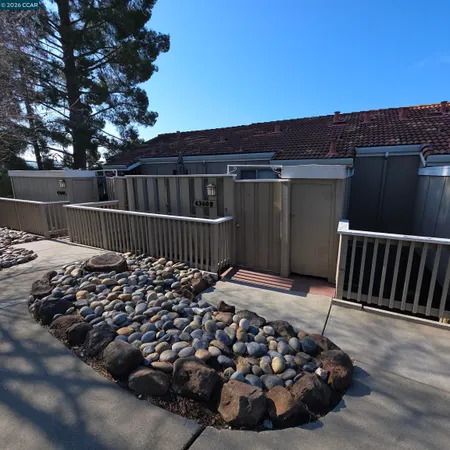 a view of a roof deck with wooden fence