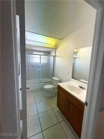 a bathroom with a double vanity sink toilet and mirror