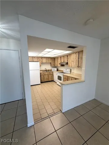 a kitchen with a stove a refrigerator and a sink