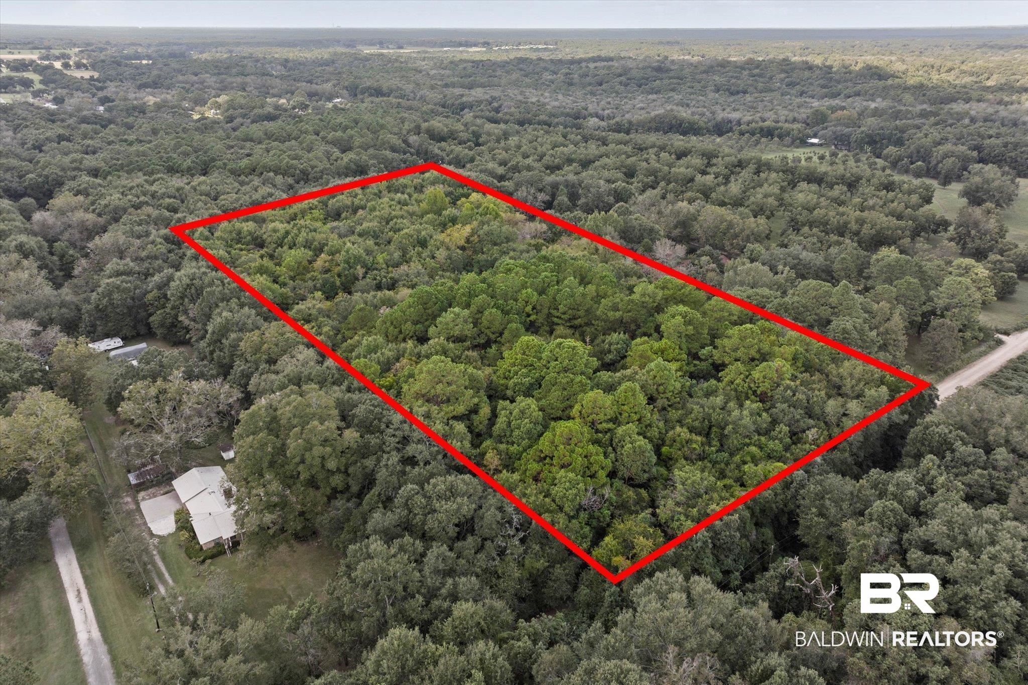 0 Dick Turner Road Grand Bay, AL 36541 - Photo 9 of 13 Aerial view of property and surrounding area featuring property boundaries highlighted and a heavily wooded area