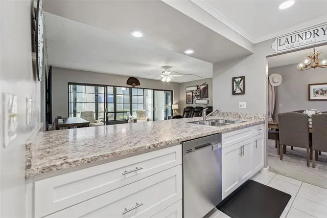 a bathroom with a granite countertop sink and a large mirror