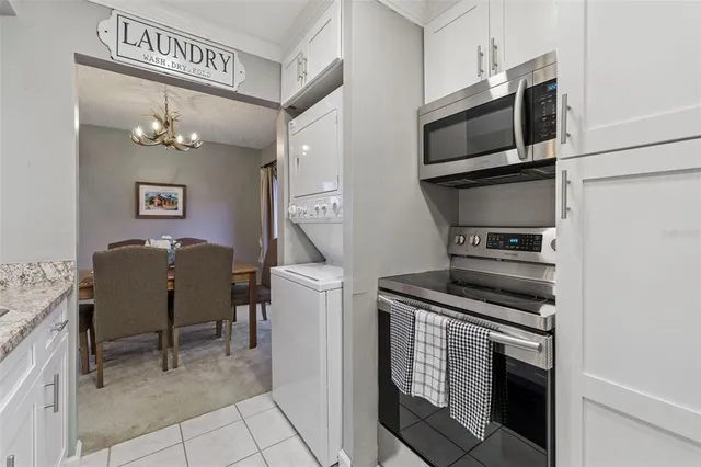 a view of kitchen with sink refrigerator and natural light
