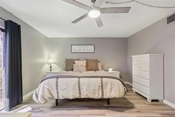a bedroom with a bed and a ceiling fan