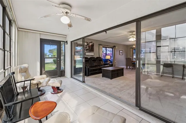 a living room with furniture a chandelier and a large window