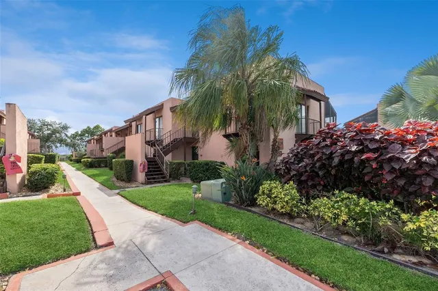 a view of a house with a yard and plants