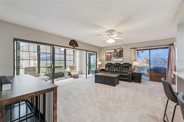 a living room with furniture and large windows