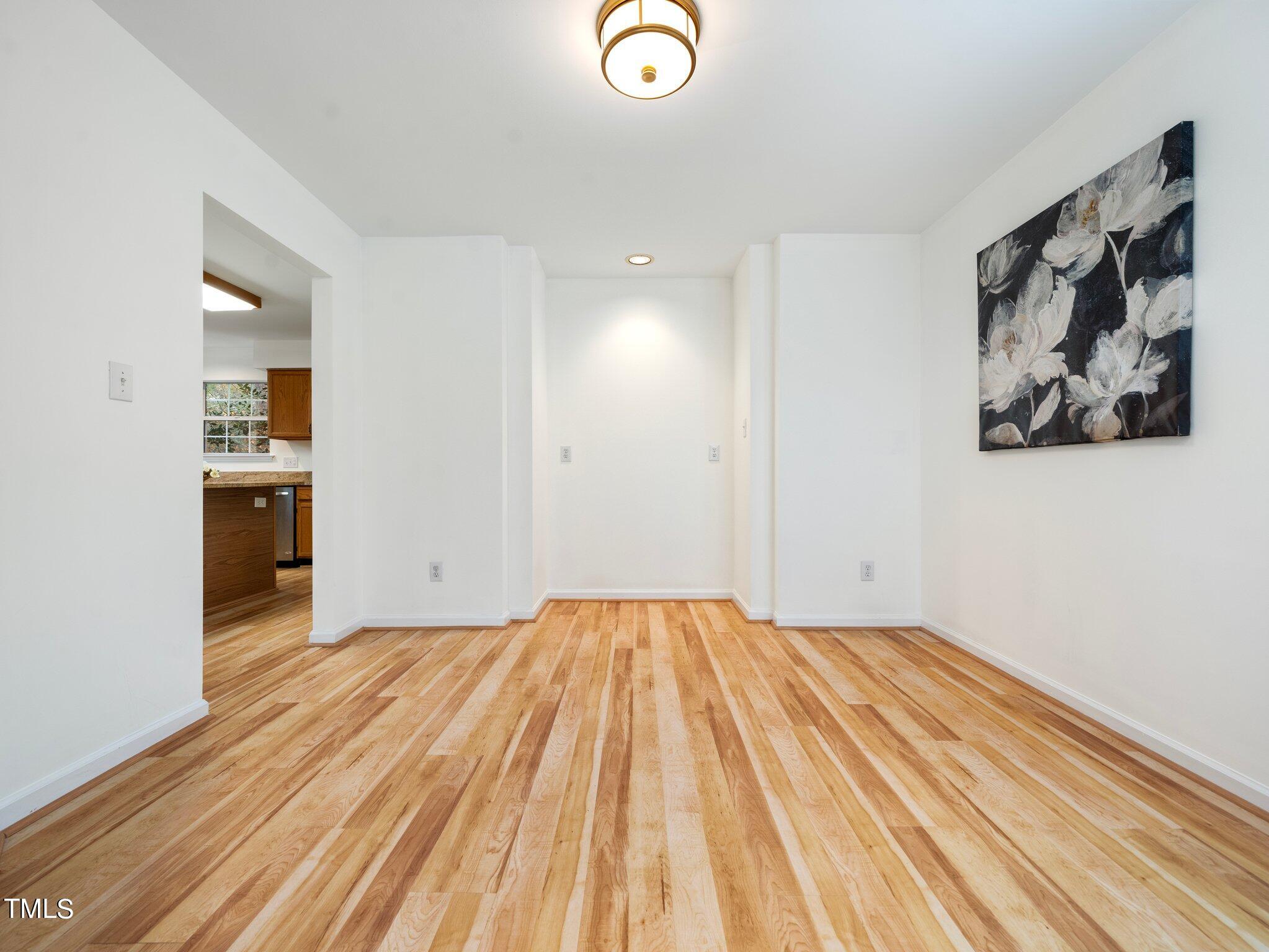 112 Riva Trace Drive Cary, NC 27513 - Photo 12 of 29 a view of empty room with wooden floor