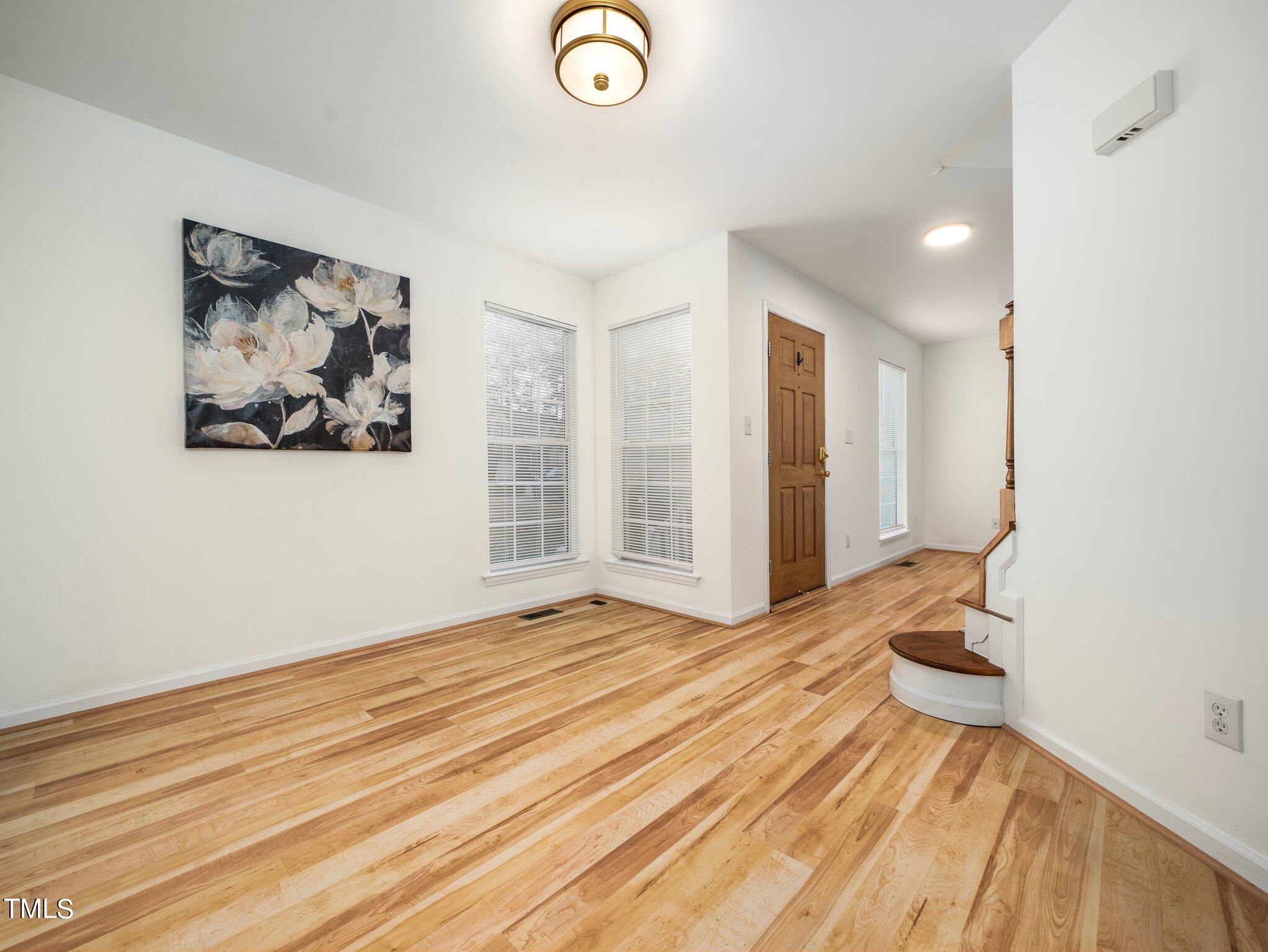 112 Riva Trace Drive Cary, NC 27513 - Photo 13 of 29 a view of a bedroom with wooden floor and bedroom