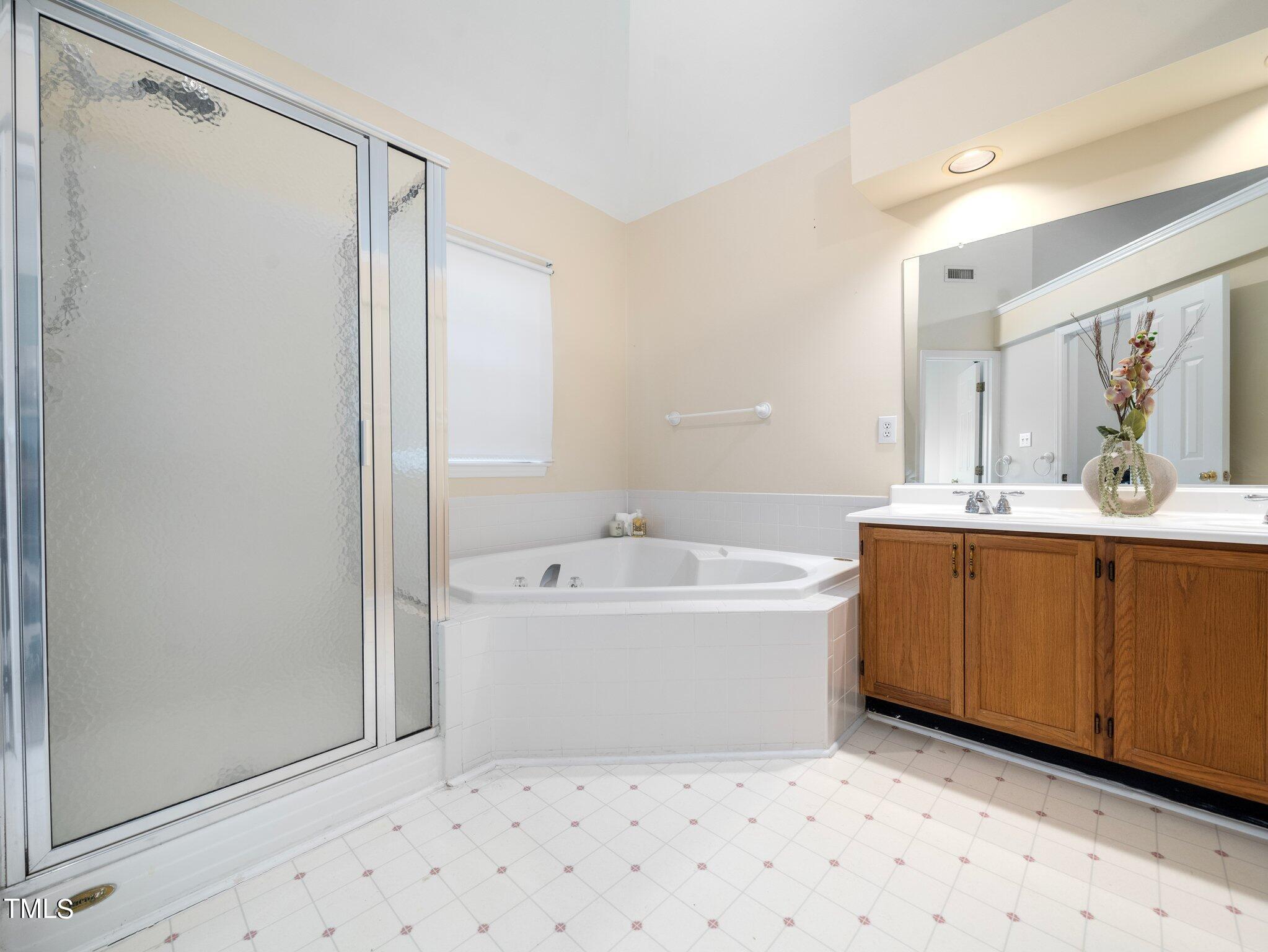 112 Riva Trace Drive Cary, NC 27513 - Photo 16 of 29 a bathroom with a bathtub sink and mirror