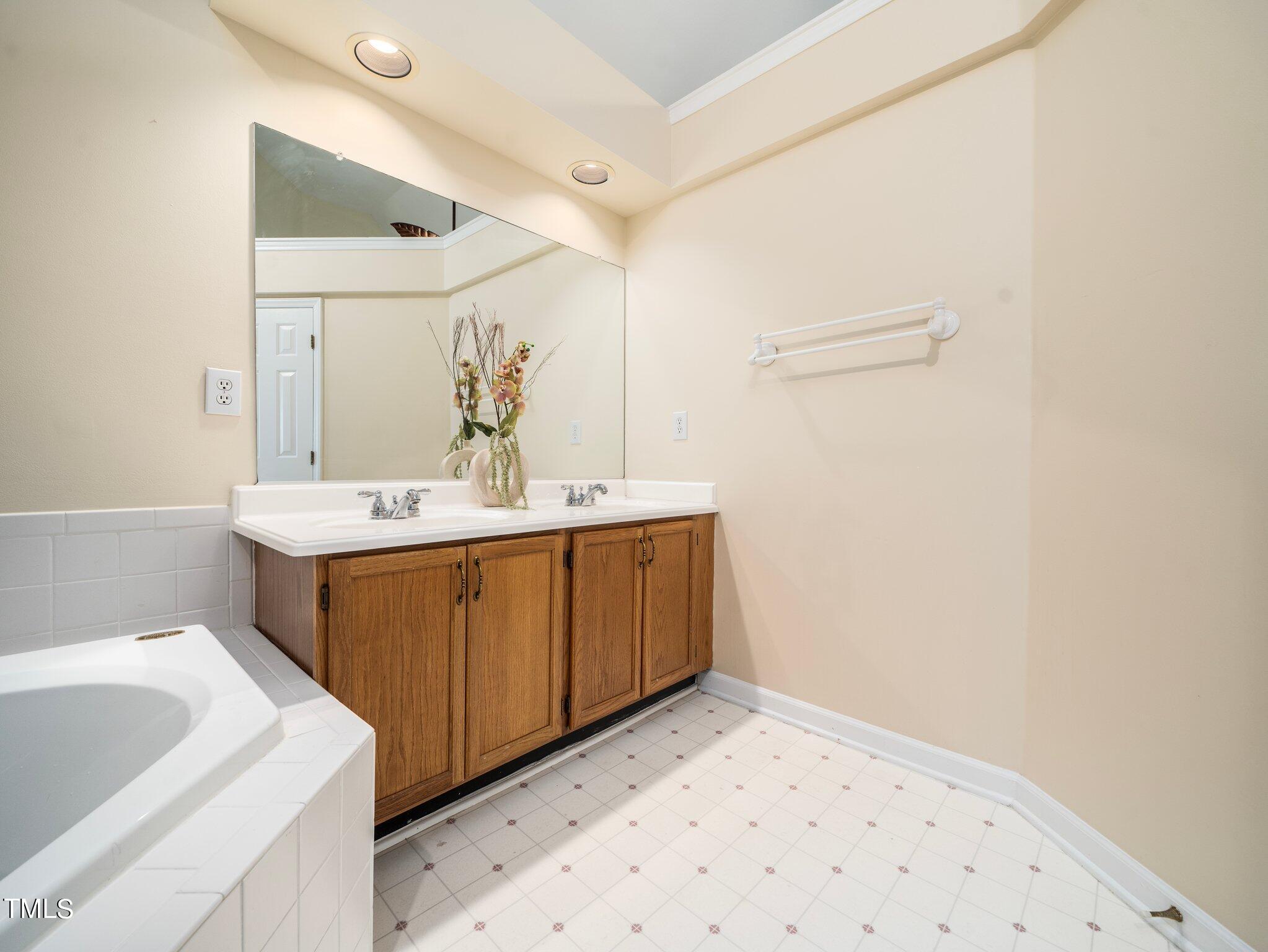 112 Riva Trace Drive Cary, NC 27513 - Photo 17 of 29 a bathroom with a sink and a mirror