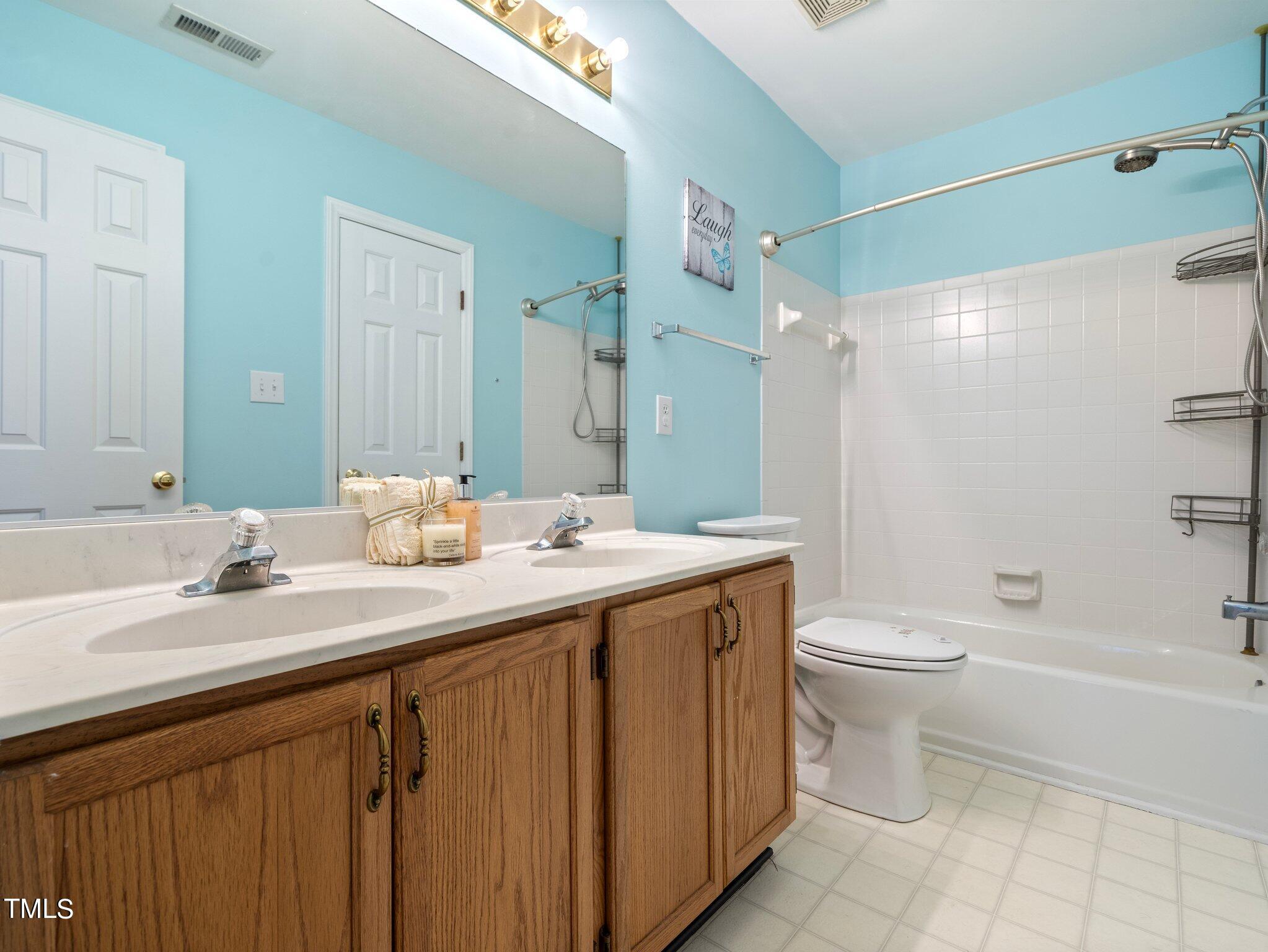 112 Riva Trace Drive Cary, NC 27513 - Photo 19 of 29 a bathroom with a double vanity sink toilet and shower