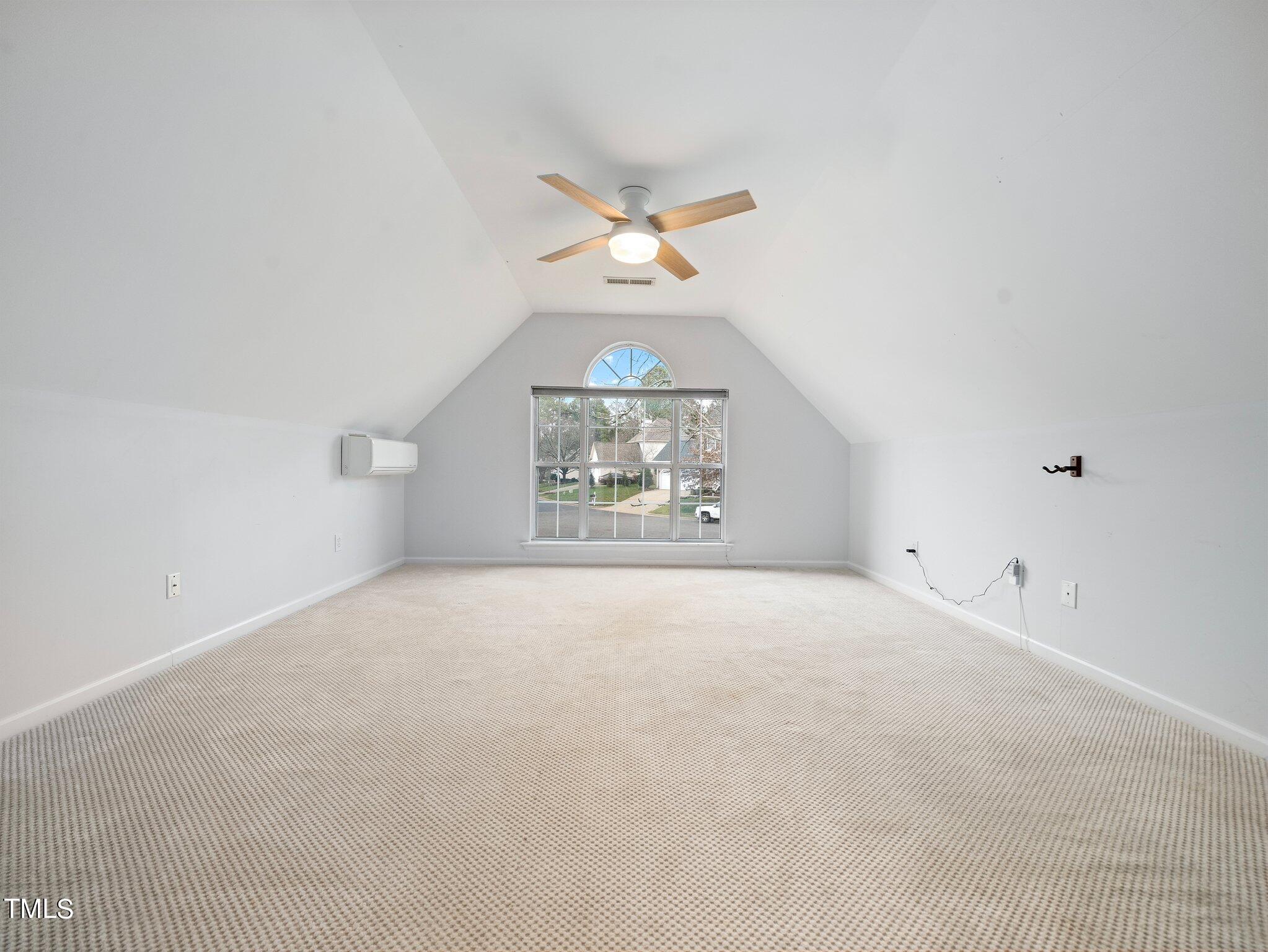 112 Riva Trace Drive Cary, NC 27513 - Photo 21 of 29 an empty room with a chandelier fan and windows