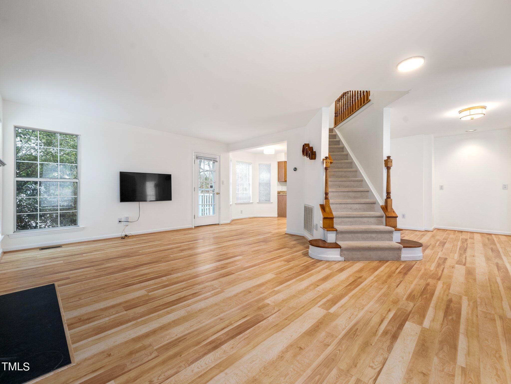 112 Riva Trace Drive Cary, NC 27513 - Photo 4 of 29 a view of empty room with wooden floor and fan
