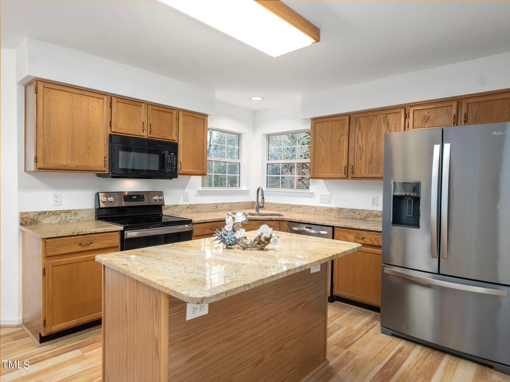 112 Riva Trace Drive Cary, NC 27513 - Photo 9 of 29 a kitchen with a stove a sink and a refrigerator