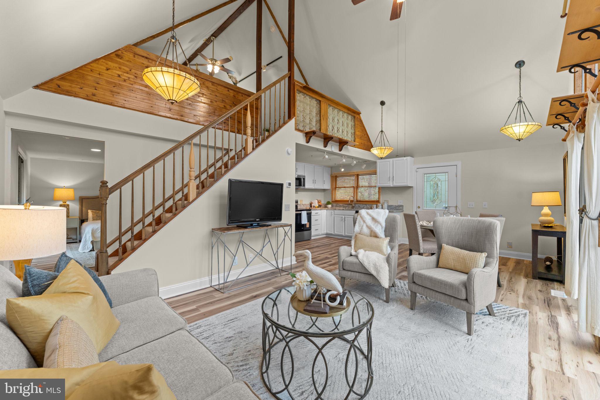 11492 Rawhide Road Lusby, MD 20657 - Photo 13 of 96 a living room with furniture and a chandelier