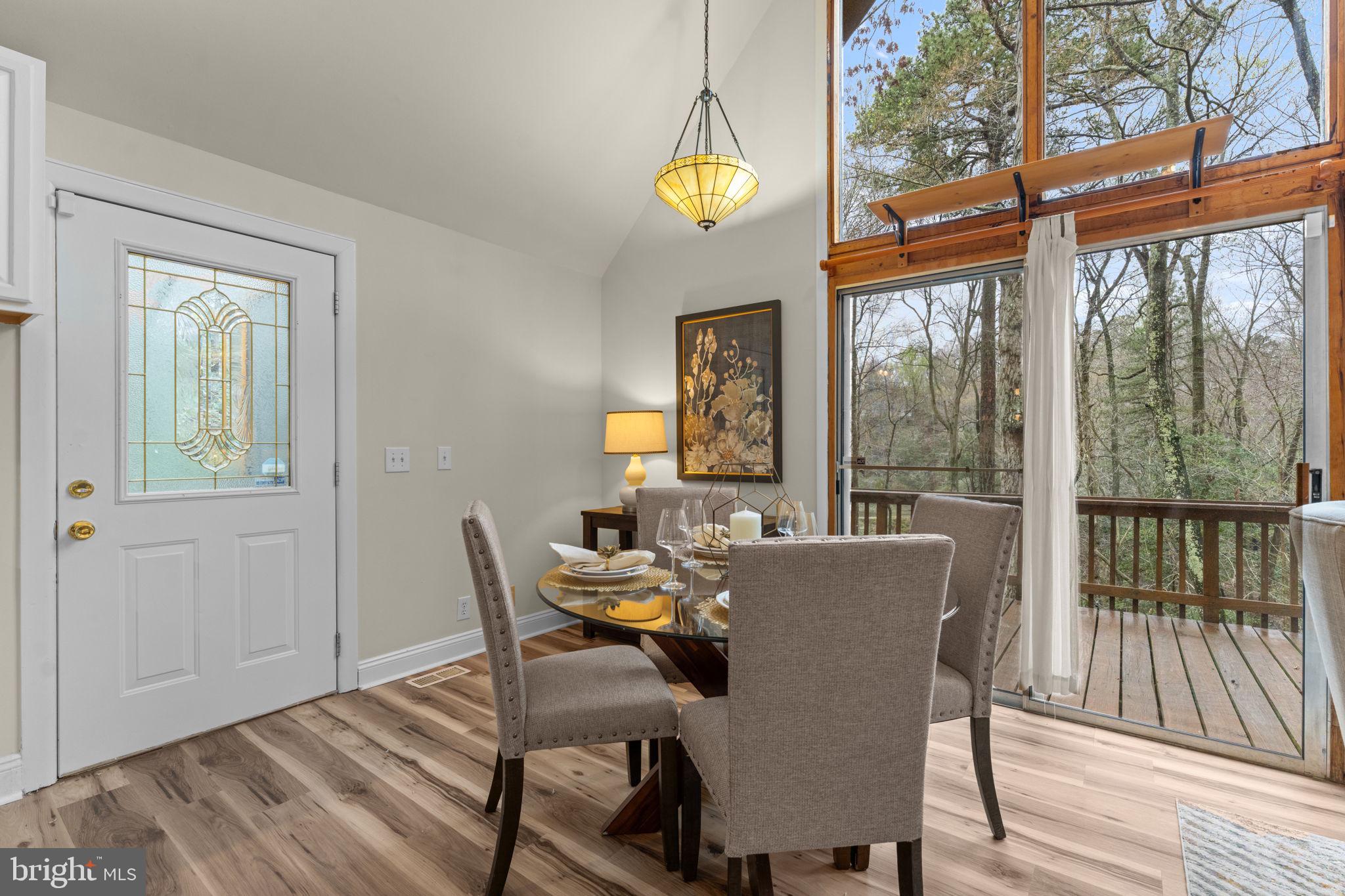 11492 Rawhide Road Lusby, MD 20657 - Photo 15 of 96 a view of a dining room with furniture window and wooden floor