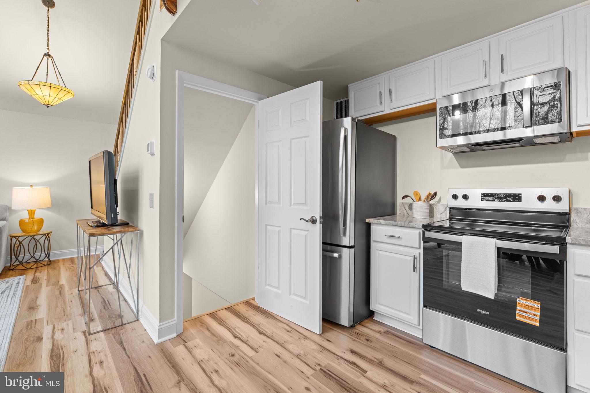 11492 Rawhide Road Lusby, MD 20657 - Photo 21 of 96 a kitchen with stainless steel appliances a stove a sink and a refrigerator