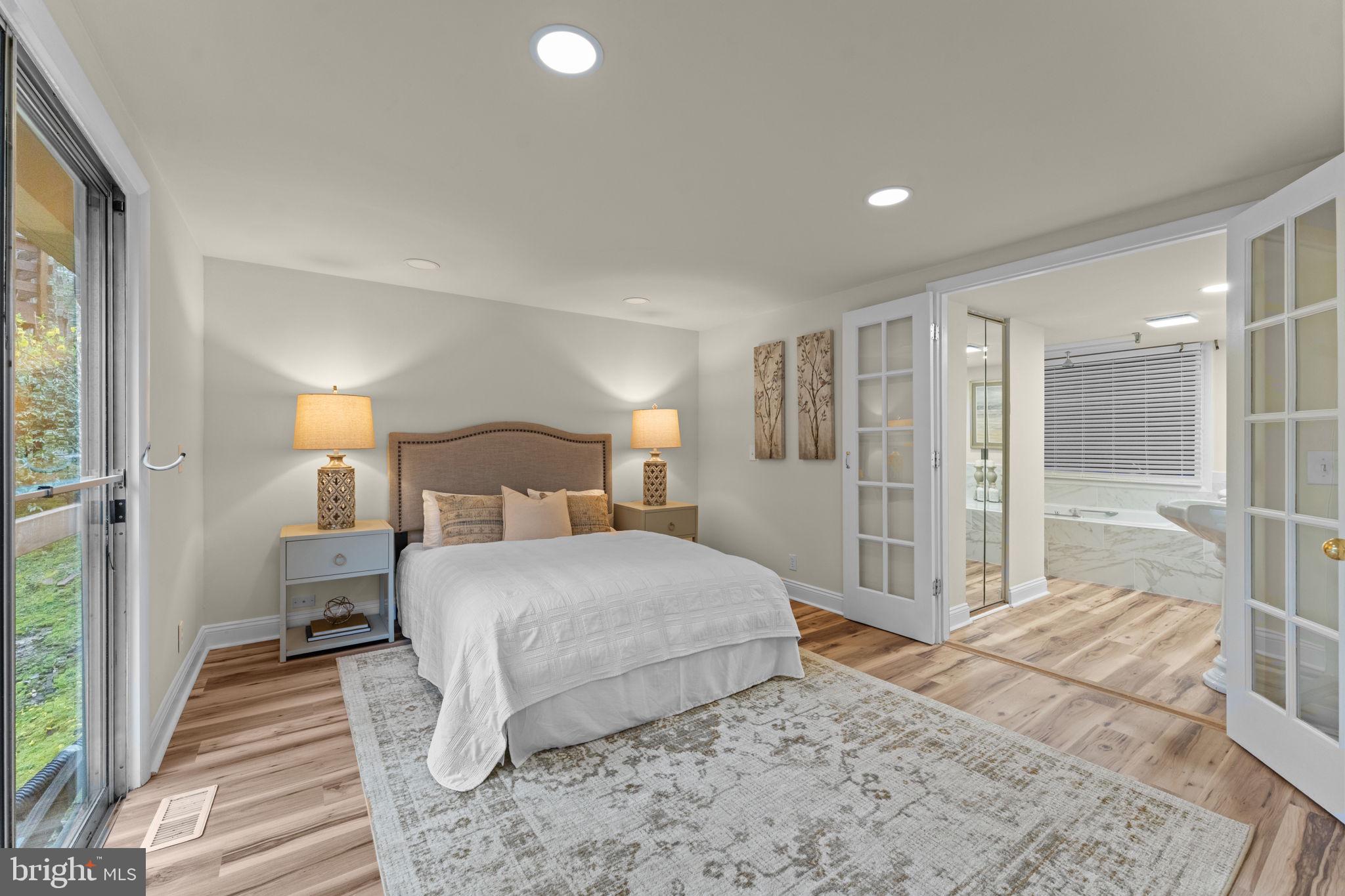 11492 Rawhide Road Lusby, MD 20657 - Photo 23 of 96 a bedroom with a large bed and a walk in closet