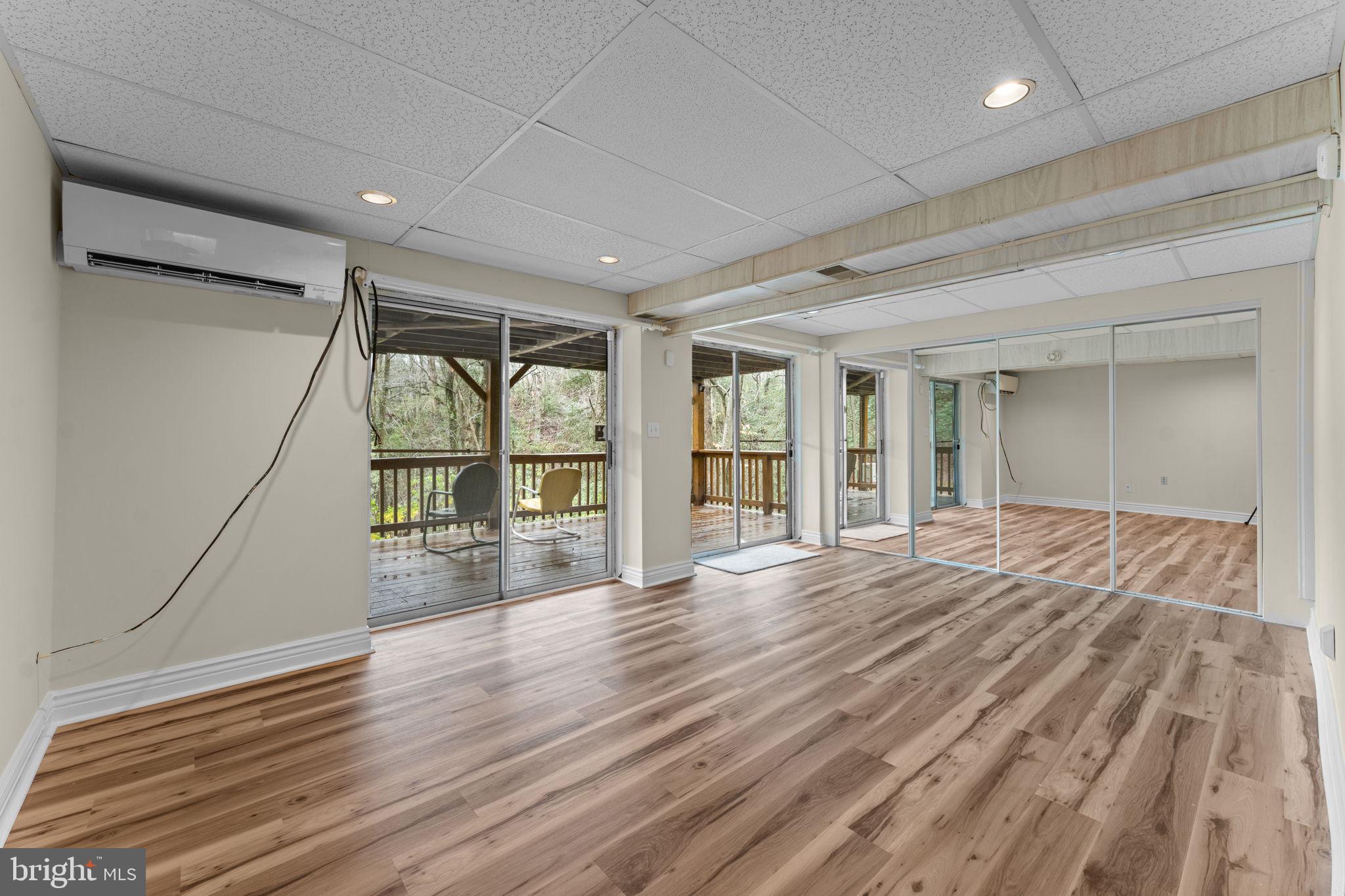 11492 Rawhide Road Lusby, MD 20657 - Photo 46 of 96 a view of empty room with wooden floor and fan