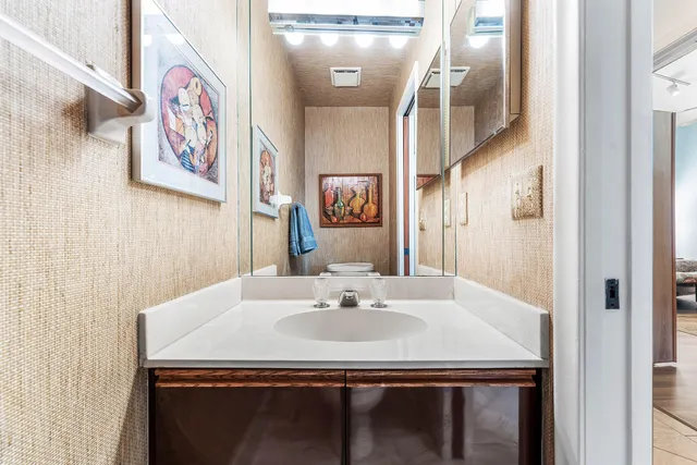 a swimming pool with large glass windows and outdoor seating