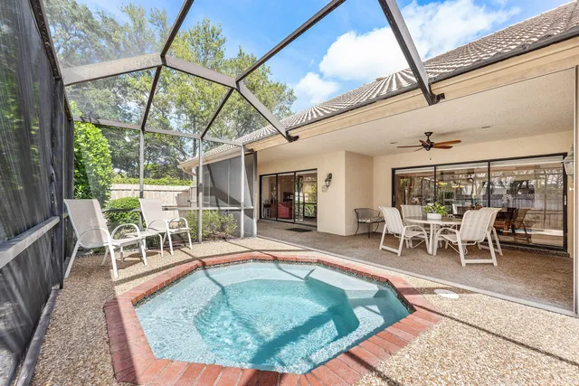 a dining room with furniture a rug and a large window