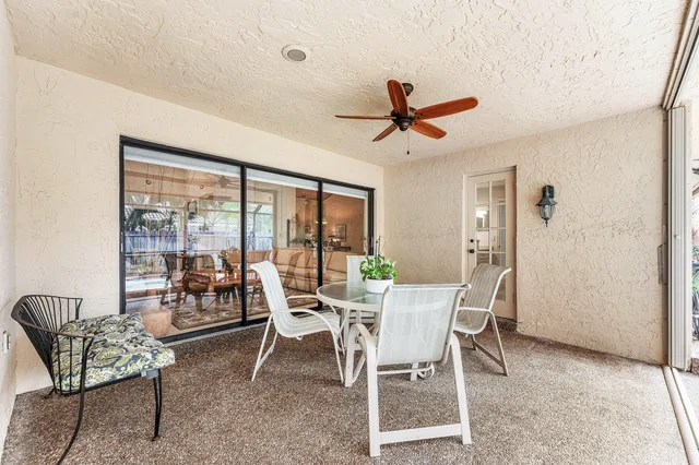 a view of a house with backyard and sitting area