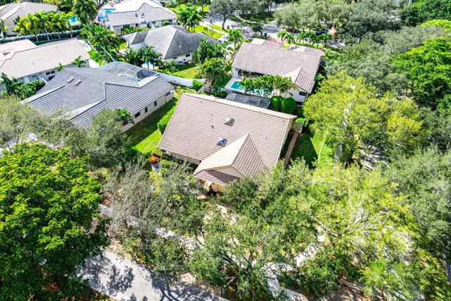 an aerial view of a house with a yard and garden
