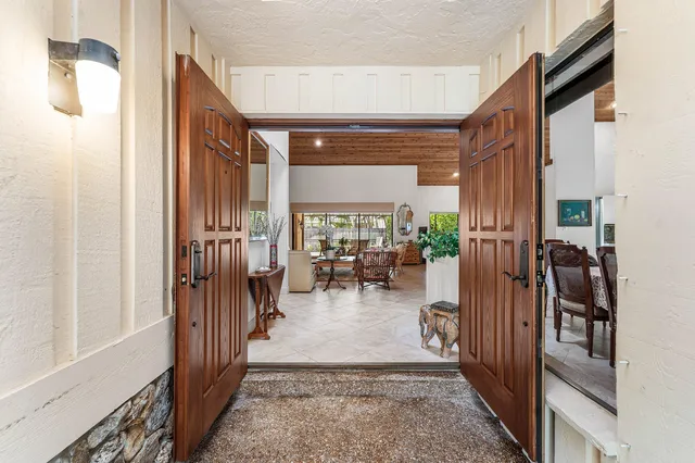 a view of a hallway with living room and dining room