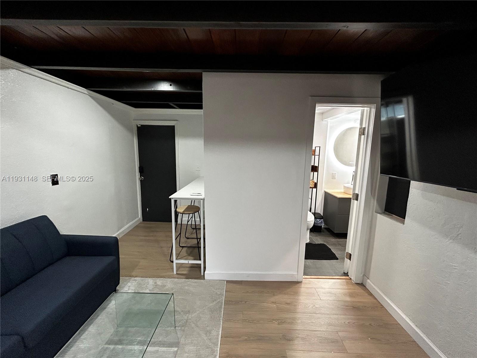 2809 Southwest 8th Street, Unit B Fort Lauderdale, FL 33312 - Photo 11 of 24 a living room with furniture and a fireplace