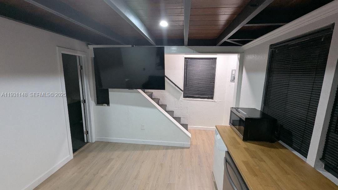 2809 Southwest 8th Street, Unit B Fort Lauderdale, FL 33312 - Photo 14 of 24 a view of a hallway with wooden floor and staircase