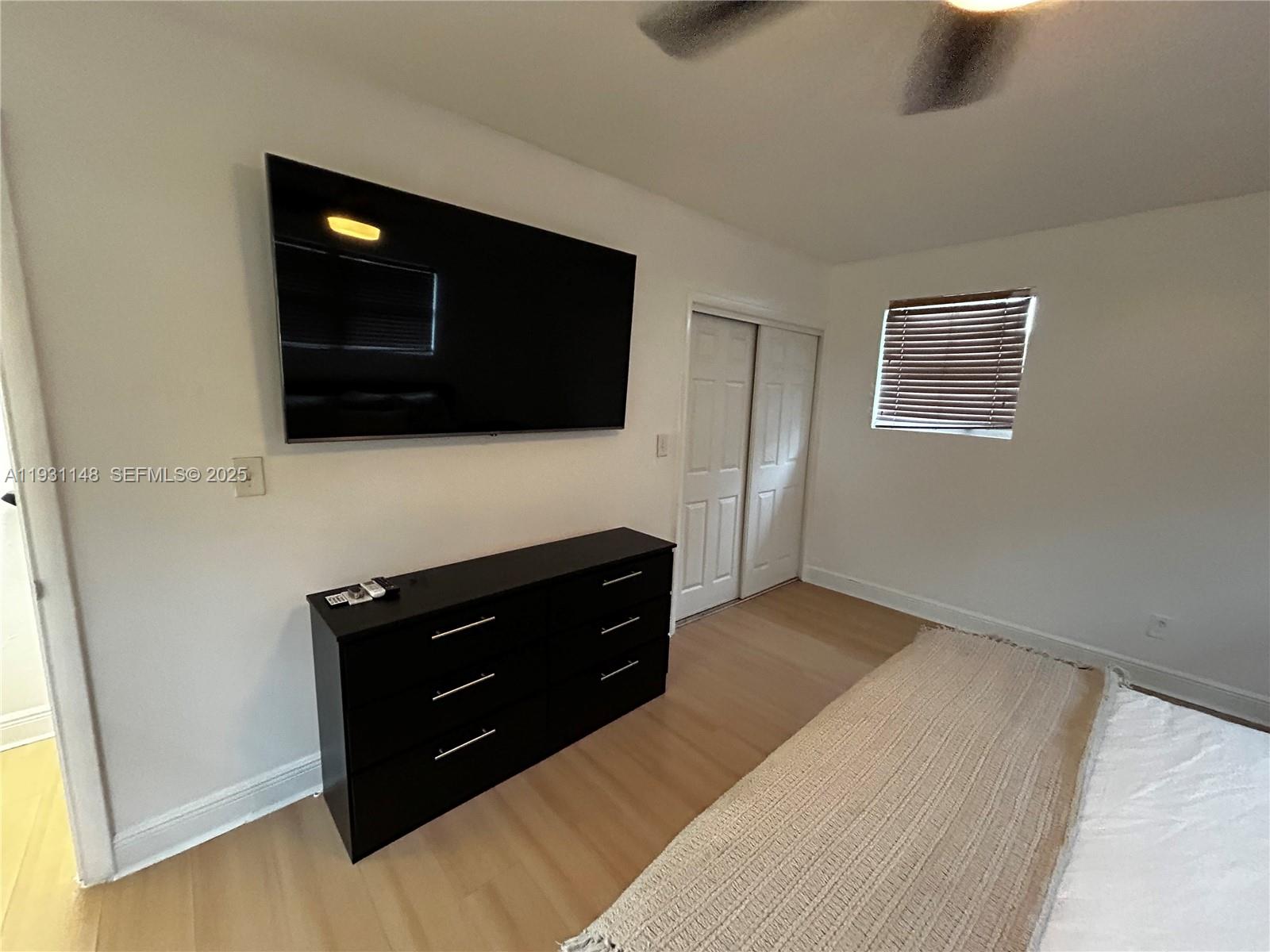 2809 Southwest 8th Street, Unit B Fort Lauderdale, FL 33312 - Photo 18 of 24 a living room with a couch and a flat screen tv