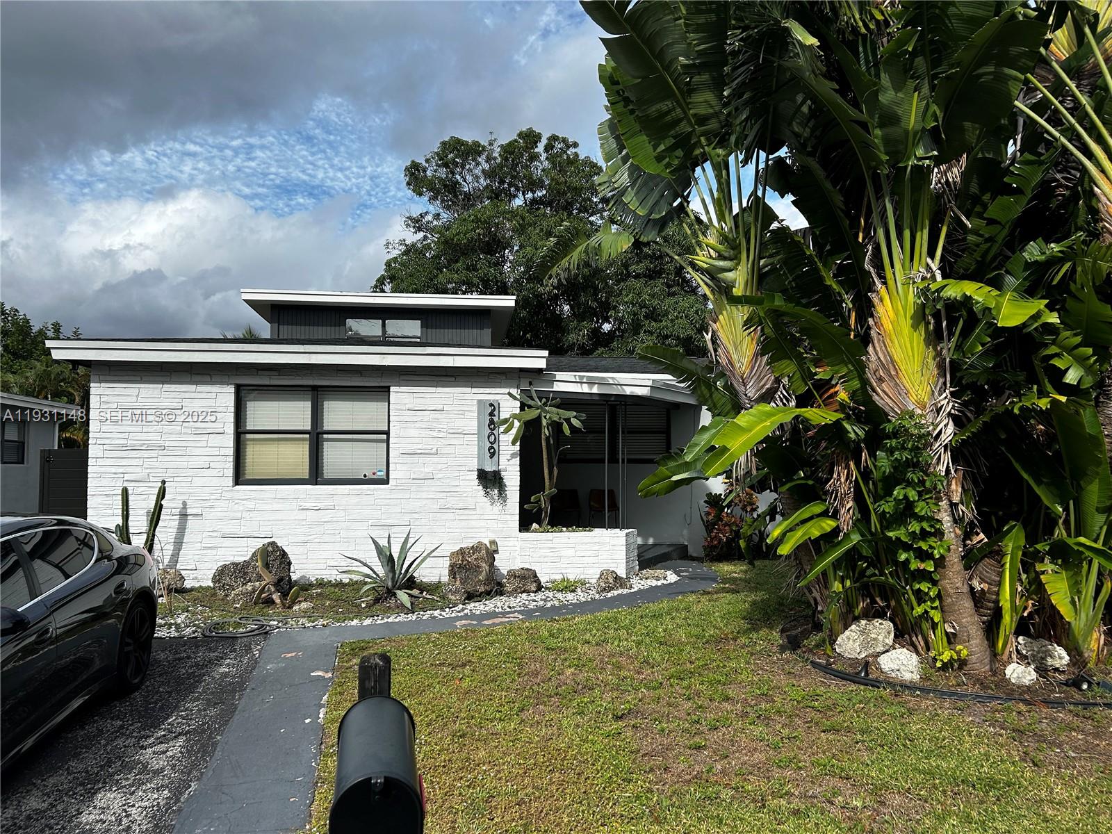 2809 Southwest 8th Street, Unit B Fort Lauderdale, FL 33312 - Photo 2 of 24 a front view of a house with a yard