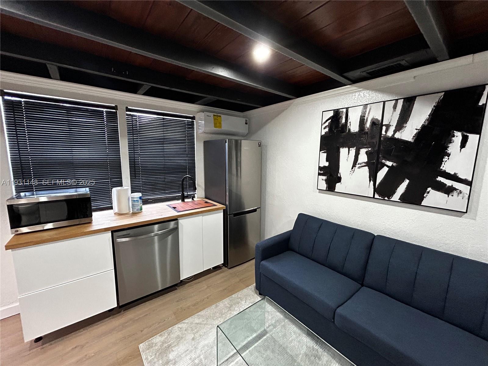 2809 Southwest 8th Street, Unit B Fort Lauderdale, FL 33312 - Photo 9 of 24 a kitchen with a sink appliances and cabinets