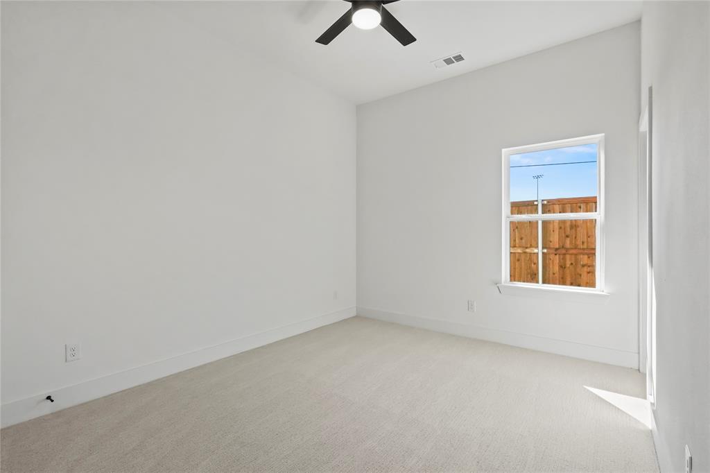 2404 52nd Street Dallas, TX 75216 - Photo 18 of 21 an empty room with a window and a ceiling fan