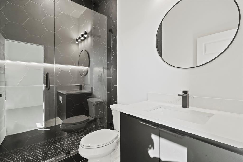 2404 52nd Street Dallas, TX 75216 - Photo 19 of 21 a bathroom with a sink a toilet and a mirror