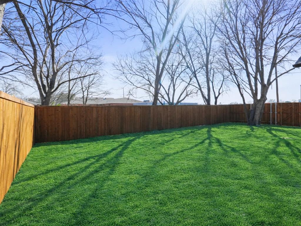 2404 52nd Street Dallas, TX 75216 - Photo 20 of 21 a view of yard with grass and wooden fence