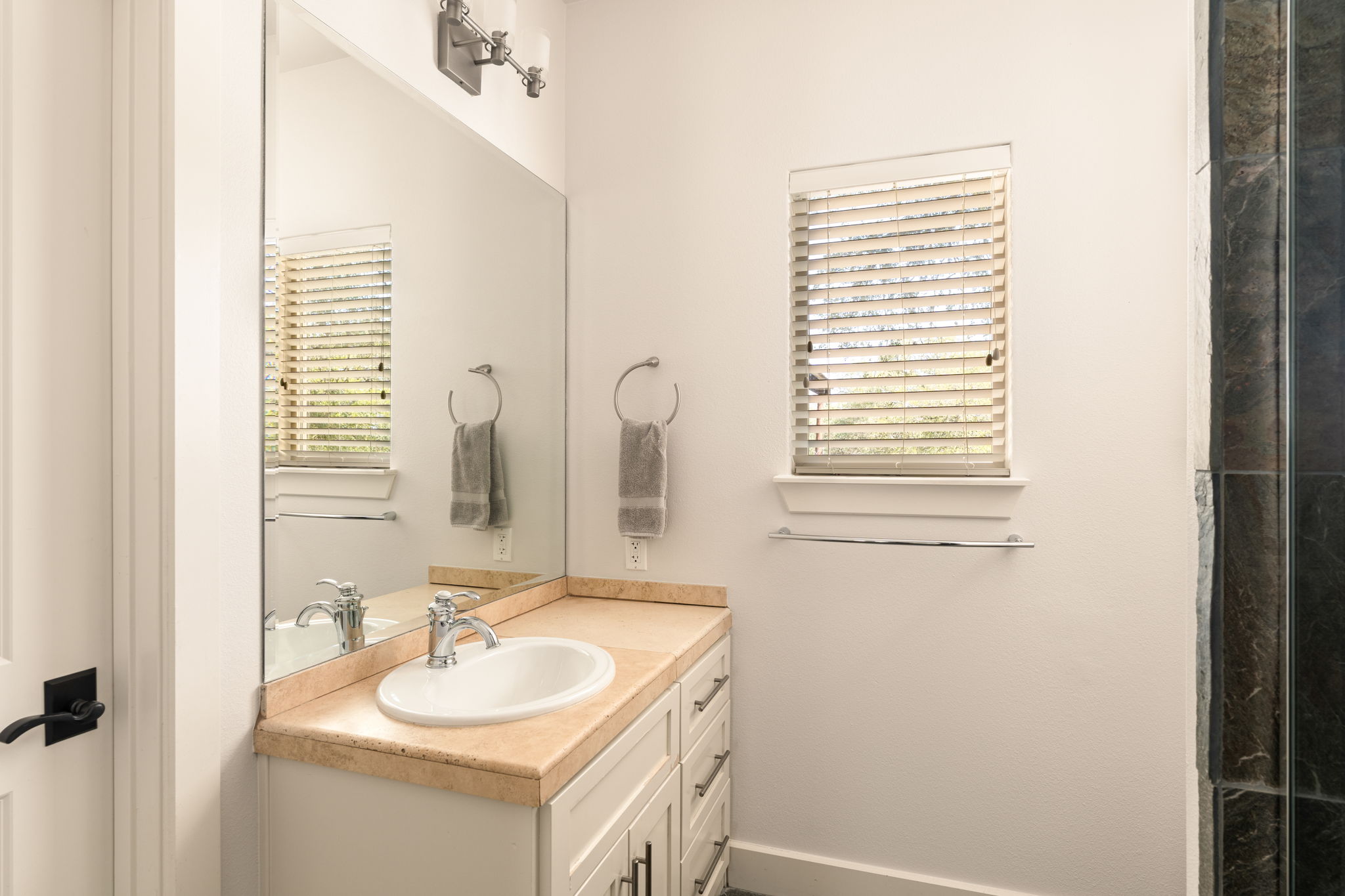 2324 Kinney Road Austin, TX 78704 - Photo 25 of 35 A classic tiled vanity pairs perfectly with neutral walls and a bright window.