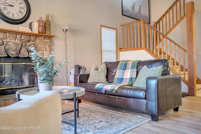 a living room with furniture a rug and a window