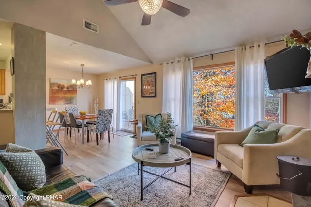 a living room with furniture and a potted plant