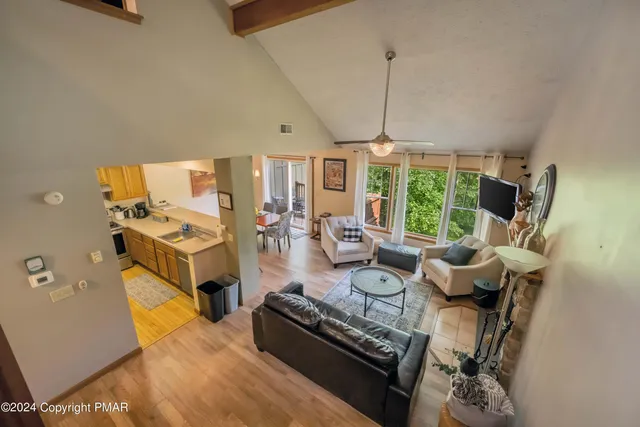 a living room with furniture a window and gym equipment