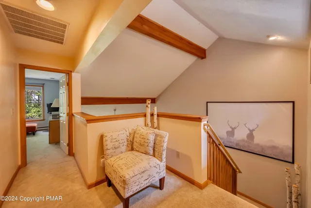 a hallway with a couch and stairs