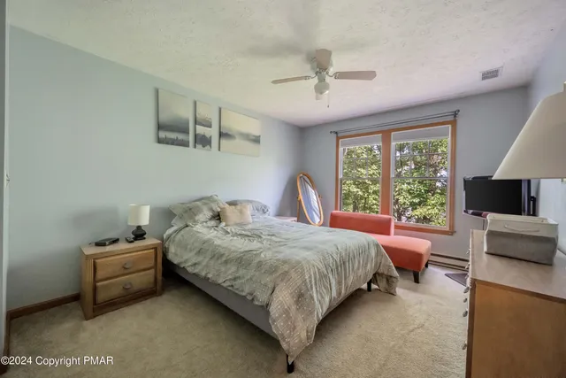 a bedroom with a bed couch and window