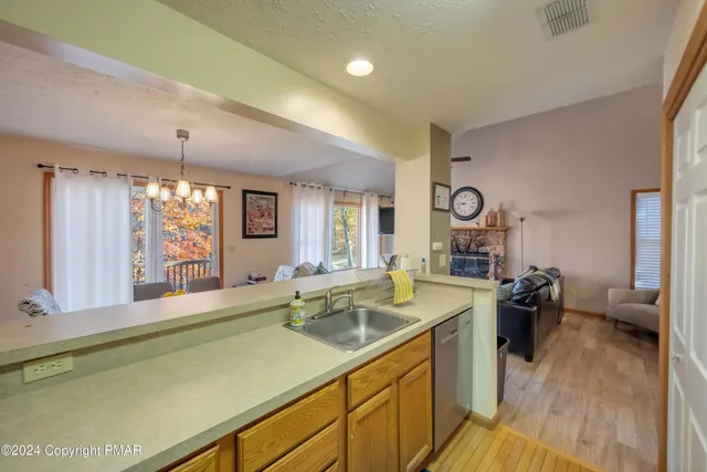a view of a kitchen counter top space with furniture and wooden floor