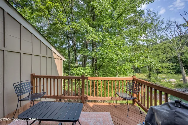 a view of a chair and table on the deck
