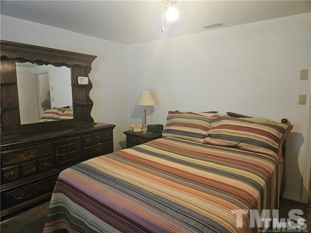 2164 Ray Road Spring Lake, NC 28390 - Photo 12 of 17 a bedroom with a bed and a dresser