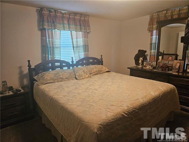 2164 Ray Road Spring Lake, NC 28390 - Photo 13 of 17 a large bed sitting in a bedroom next to a window