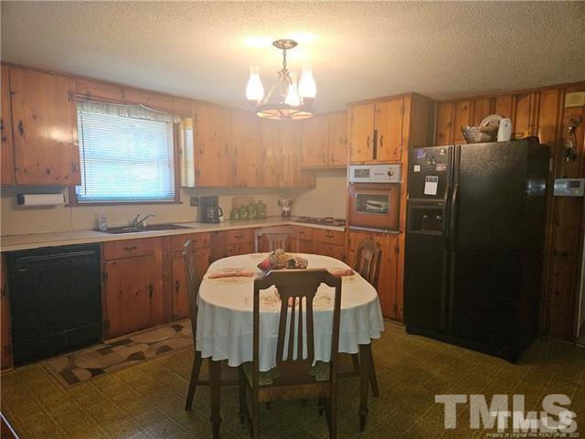 2164 Ray Road Spring Lake, NC 28390 - Photo 16 of 17 a kitchen with a table chairs and refrigerator