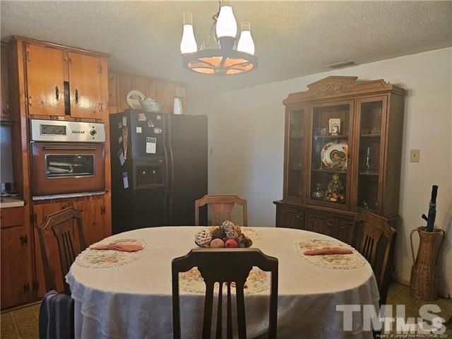 2164 Ray Road Spring Lake, NC 28390 - Photo 17 of 17 a view of a dining room with furniture and wooden floor
