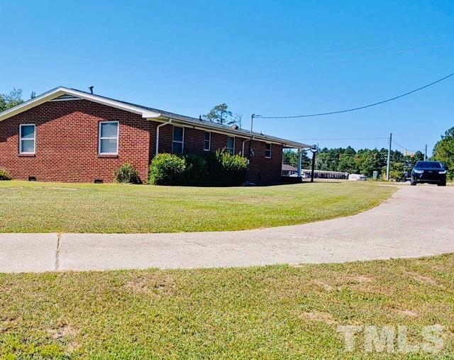 2164 Ray Road Spring Lake, NC 28390 - Photo 10 of 17 a view of a house with a yard and a large tree